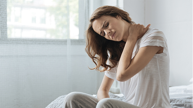 Girl suffering from pain on her shoulder